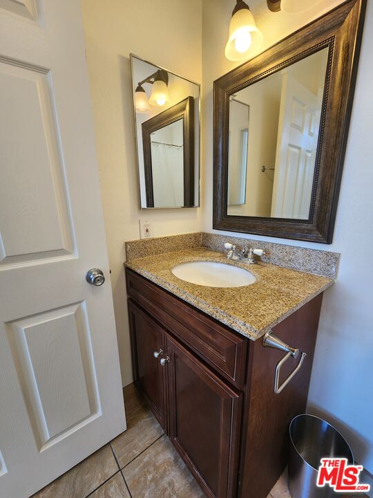 4328 Whitsett Avenue, Unit 4 Studio City, CA 91604 - Photo 30 of 73 a bathroom with a granite countertop sink and a mirror