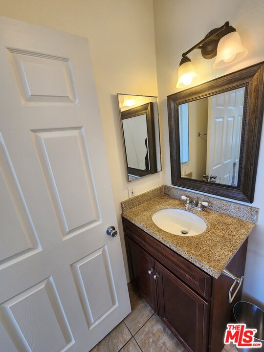 4328 Whitsett Avenue, Unit 4 Studio City, CA 91604 - Photo 31 of 73 a bathroom with a granite countertop sink and a mirror