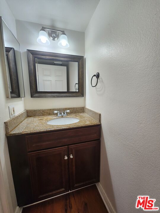 4328 Whitsett Avenue, Unit 4 Studio City, CA 91604 - Photo 56 of 73 a bathroom with a granite countertop sink a mirror and a