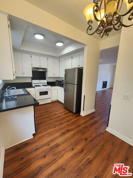 4328 Whitsett Avenue, Unit 4 Studio City, CA 91604 - Photo 63 of 73 a kitchen with wooden floors and refrigerator