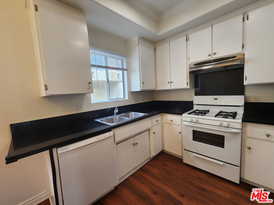4328 Whitsett Avenue, Unit 4 Studio City, CA 91604 - Photo 65 of 73 a kitchen with granite countertop white cabinets and white appliances