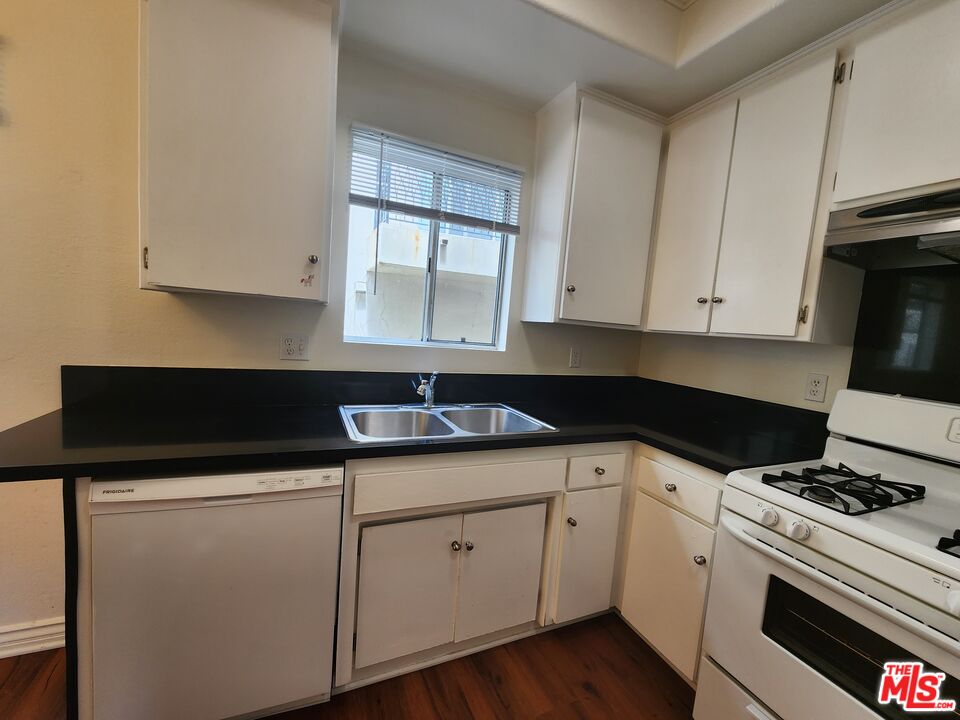 4328 Whitsett Avenue, Unit 4 Studio City, CA 91604 - Photo 66 of 73 a kitchen with granite countertop white cabinets and white appliances