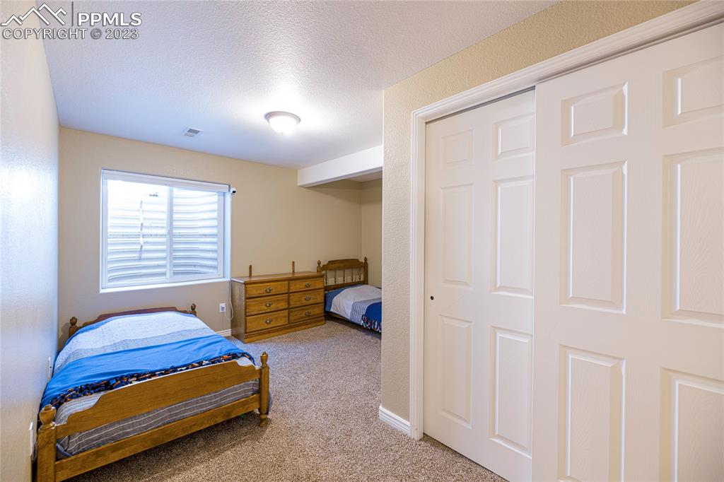 12713 Pine Valley Circle Peyton, CO 80831 - Photo 17 of 26 a bedroom with furniture and a window