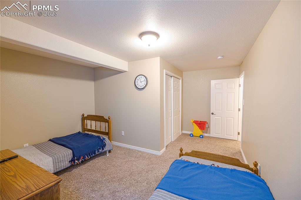 12713 Pine Valley Circle Peyton, CO 80831 - Photo 18 of 26 a bed room with a bed and a window