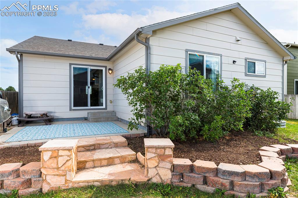 12713 Pine Valley Circle Peyton, CO 80831 - Photo 23 of 26 a front view of a house with garden