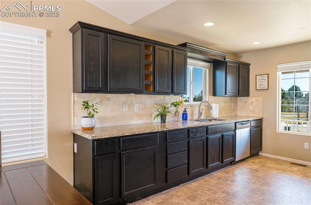 12713 Pine Valley Circle Peyton, CO 80831 - Photo 4 of 26 a bathroom with a sink double vanity granite and a mirror