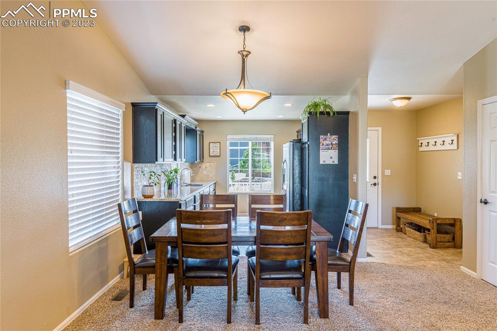 12713 Pine Valley Circle Peyton, CO 80831 - Photo 5 of 26 a dining room with furniture and window