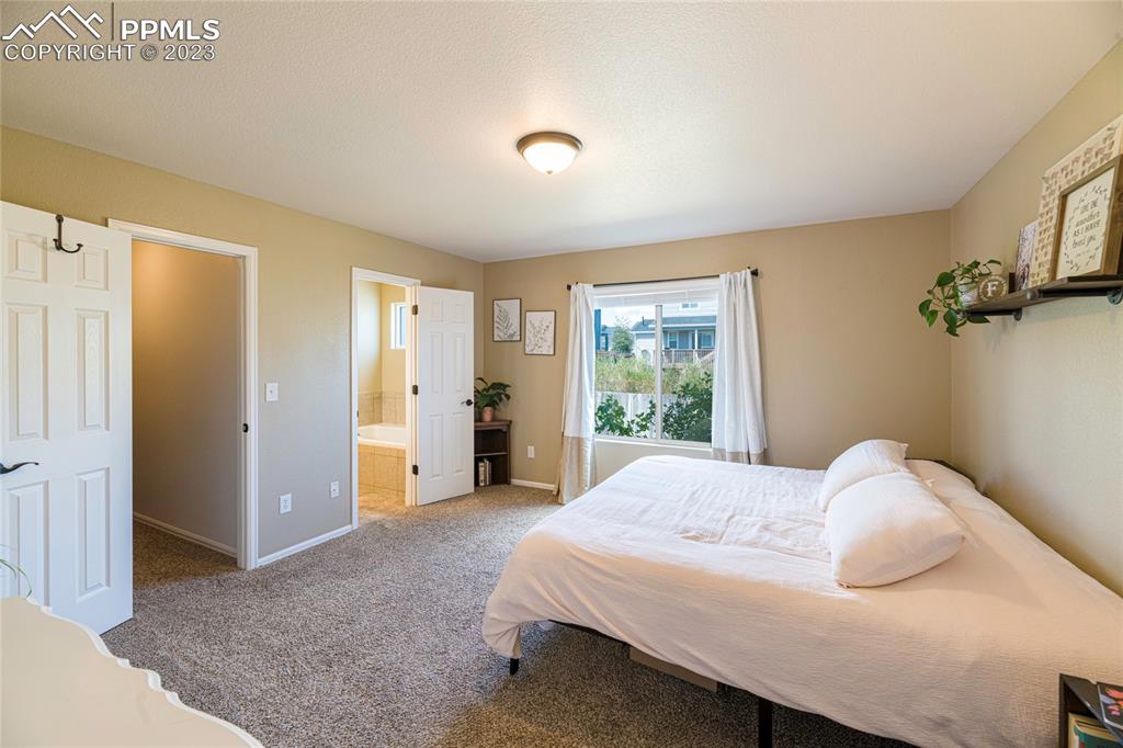 12713 Pine Valley Circle Peyton, CO 80831 - Photo 6 of 26 a bedroom with a bed and a window