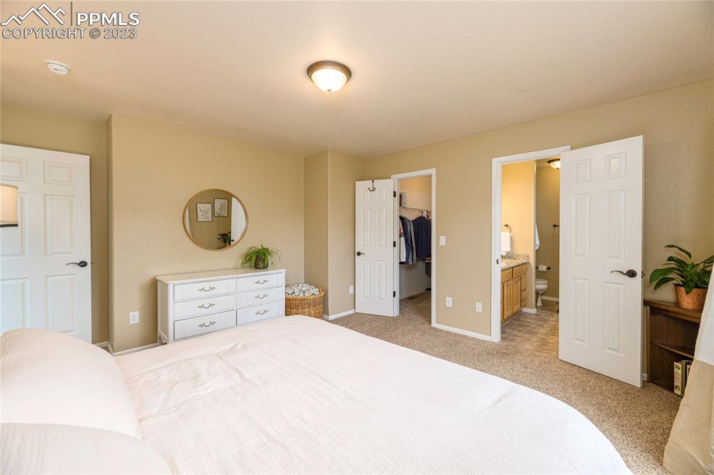 12713 Pine Valley Circle Peyton, CO 80831 - Photo 7 of 26 a bedroom with a large bed and dresser