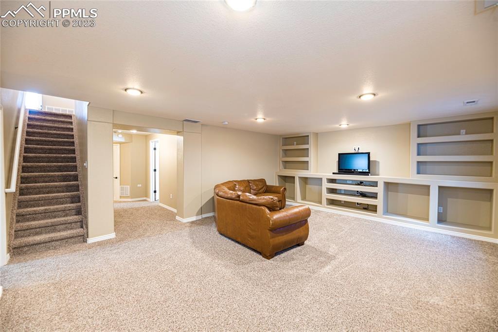 12713 Pine Valley Circle Peyton, CO 80831 - Photo 9 of 26 a living room with furniture and a flat screen tv