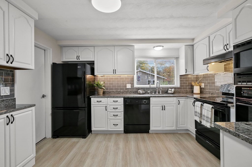 26 Doris Road Framingham, MA 01701 - Photo 3 of 36 a kitchen with granite countertop a refrigerator stove top oven and sink