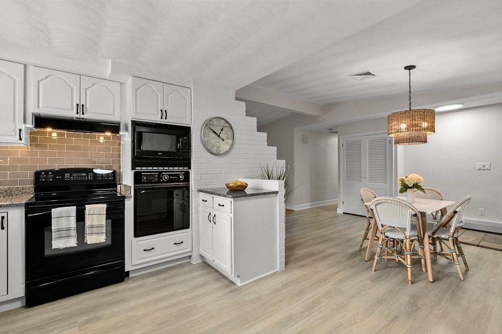 26 Doris Road Framingham, MA 01701 - Photo 4 of 36 a kitchen with stainless steel appliances kitchen island hardwood floor and wooden floors