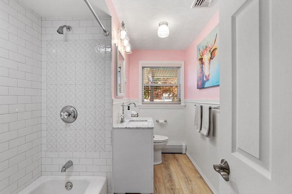 26 Doris Road Framingham, MA 01701 - Photo 10 of 36 a bathroom with a sink a toilet a window and shower