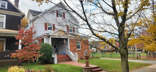 a front view of a house with garden