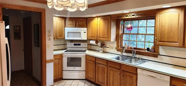 a kitchen with stainless steel appliances granite countertop a sink and a cabinets