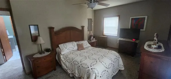 a bedroom with a bed and a mirror
