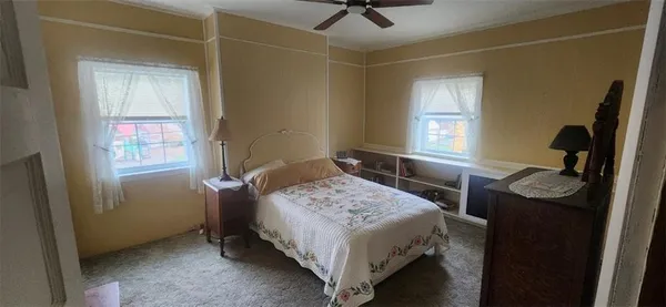 a bedroom with a bed and a dresser