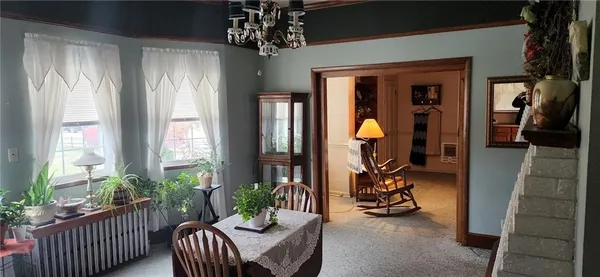 a living room with furniture a flat screen tv and a window