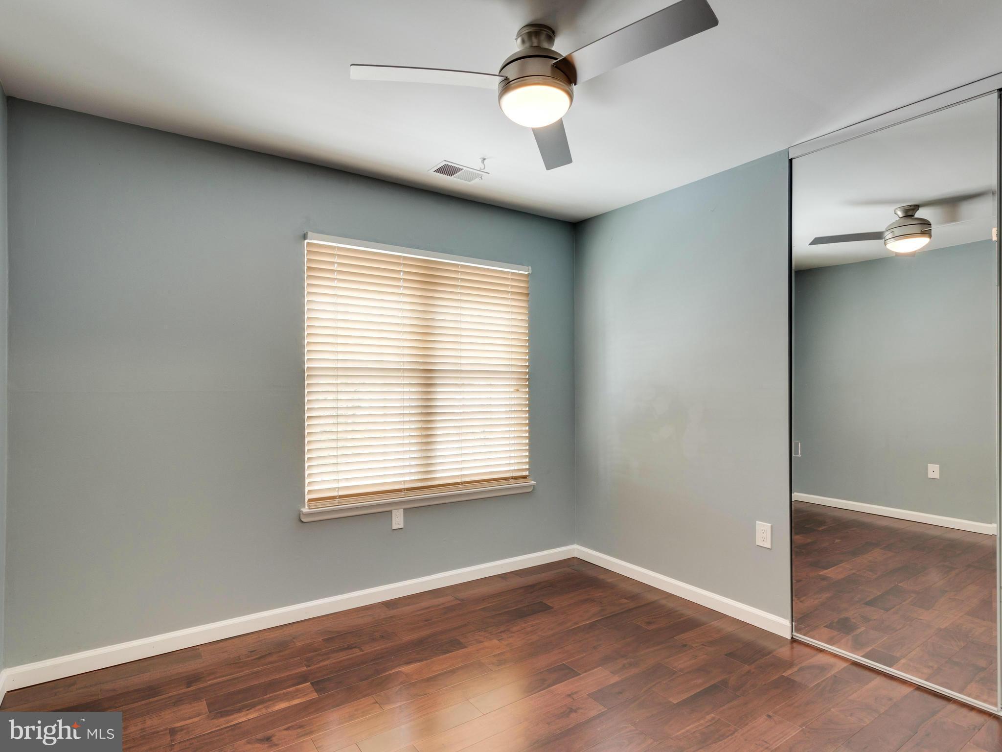 7604 Chancellor Way Springfield, VA 22153 - Photo 21 of 30 a view of an empty room with wooden floor and a window