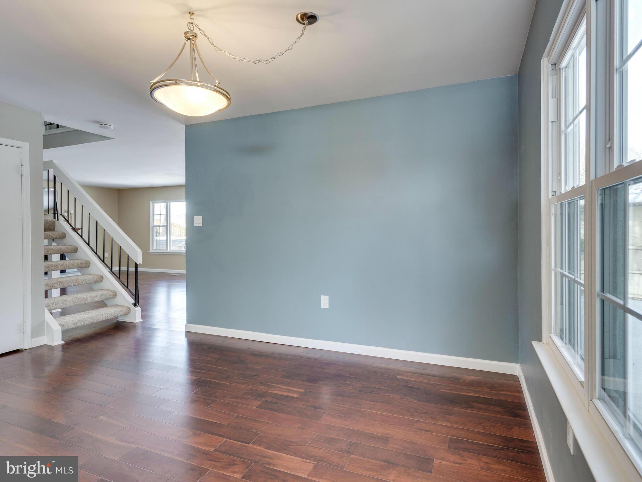 7604 Chancellor Way Springfield, VA 22153 - Photo 3 of 30 a view of an empty room with wooden floor and a window