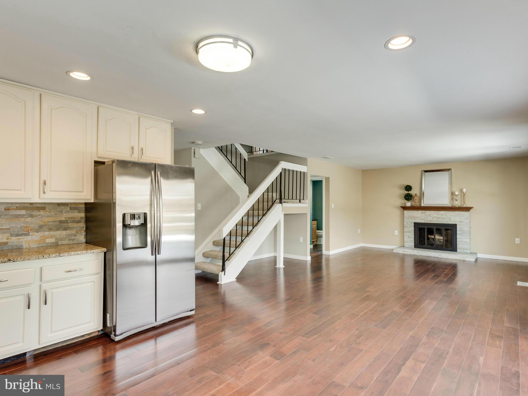7604 Chancellor Way Springfield, VA 22153 - Photo 6 of 30 a kitchen with stainless steel appliances granite countertop a refrigerator a stove and white cabinets with wooden floor