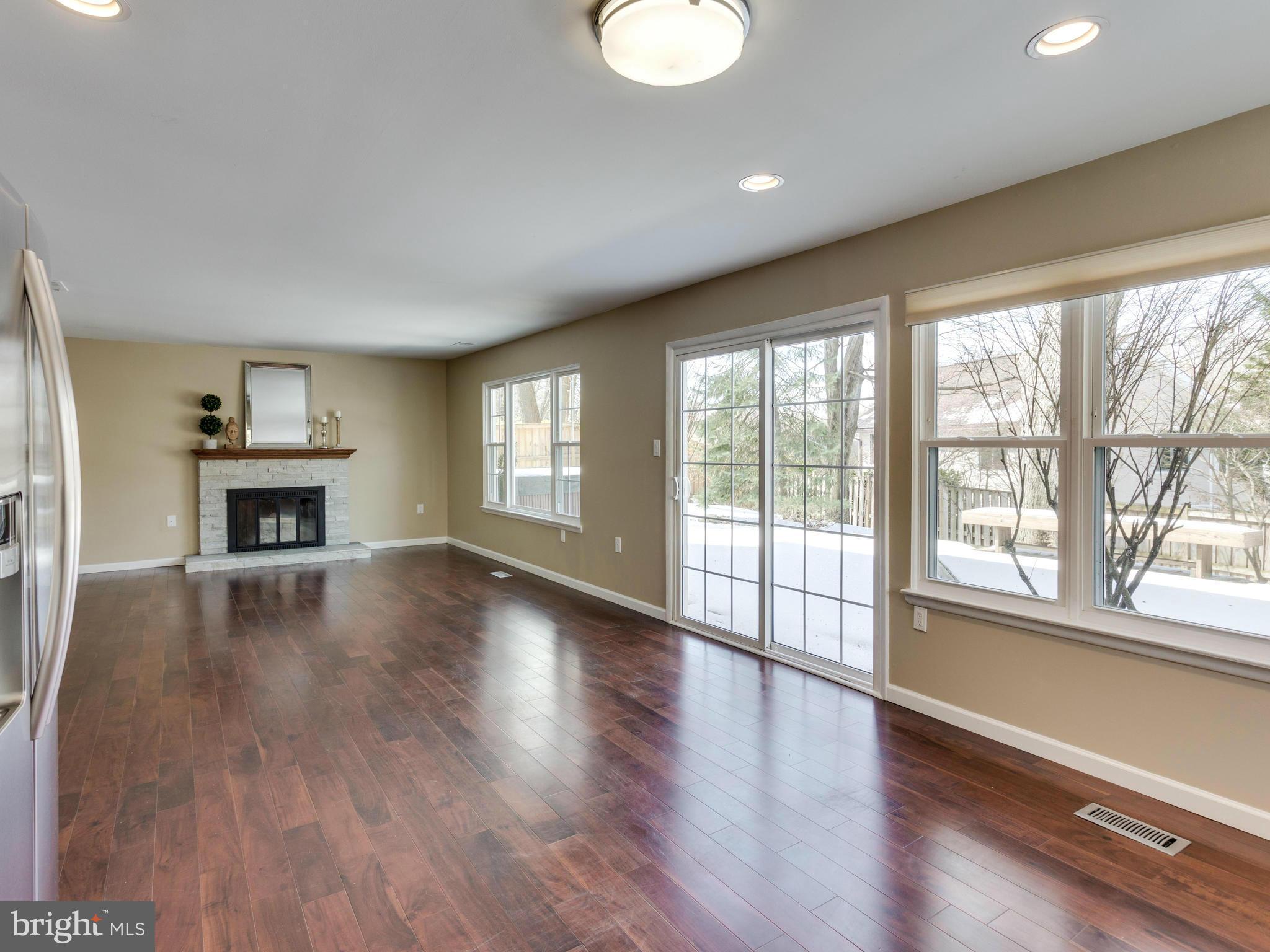 7604 Chancellor Way Springfield, VA 22153 - Photo 7 of 30 a view of an empty room with wooden floor and a window