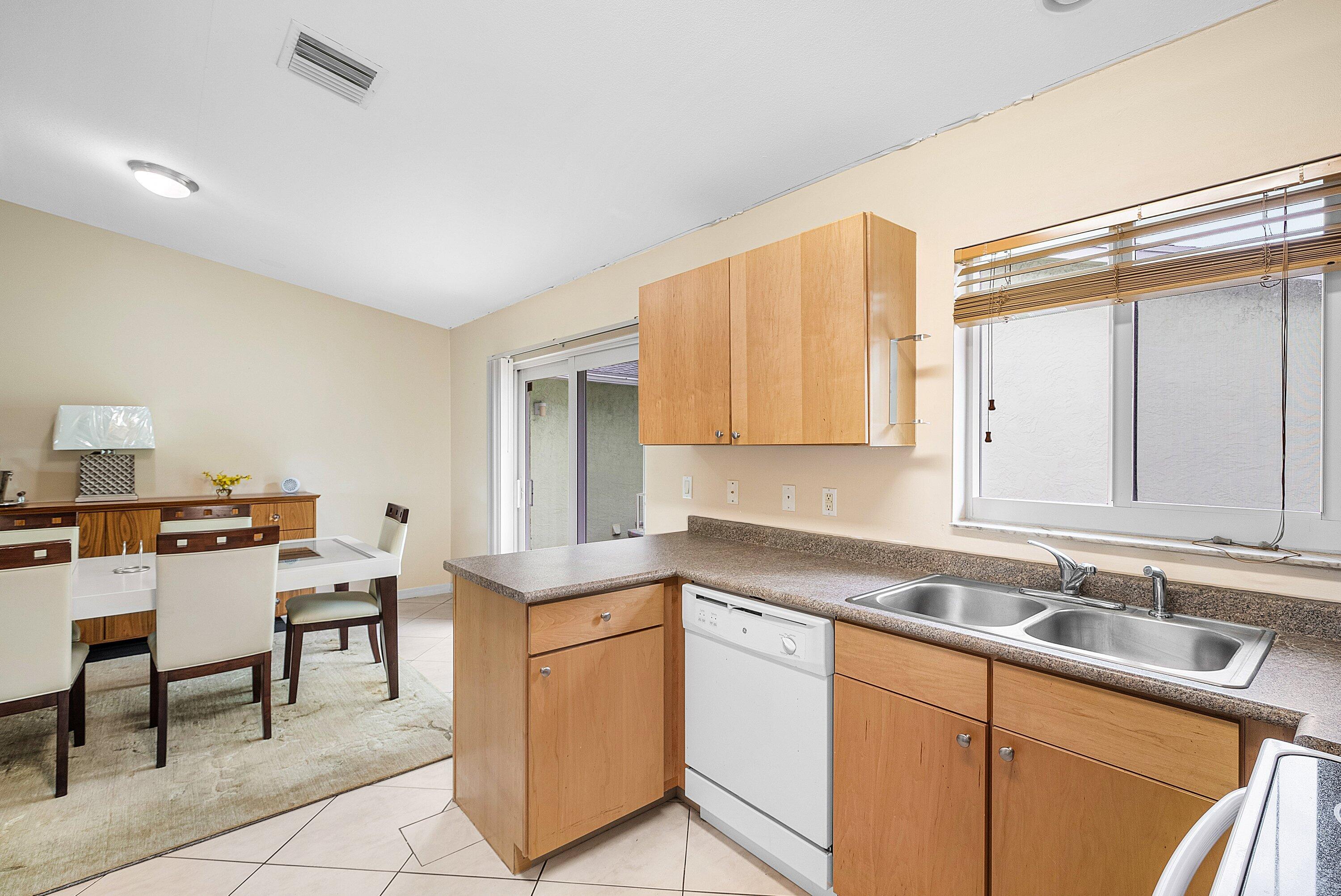 165 Northwest 8th Street Boca Raton, FL 33432 - Photo 13 of 42 a kitchen with a sink cabinets and window