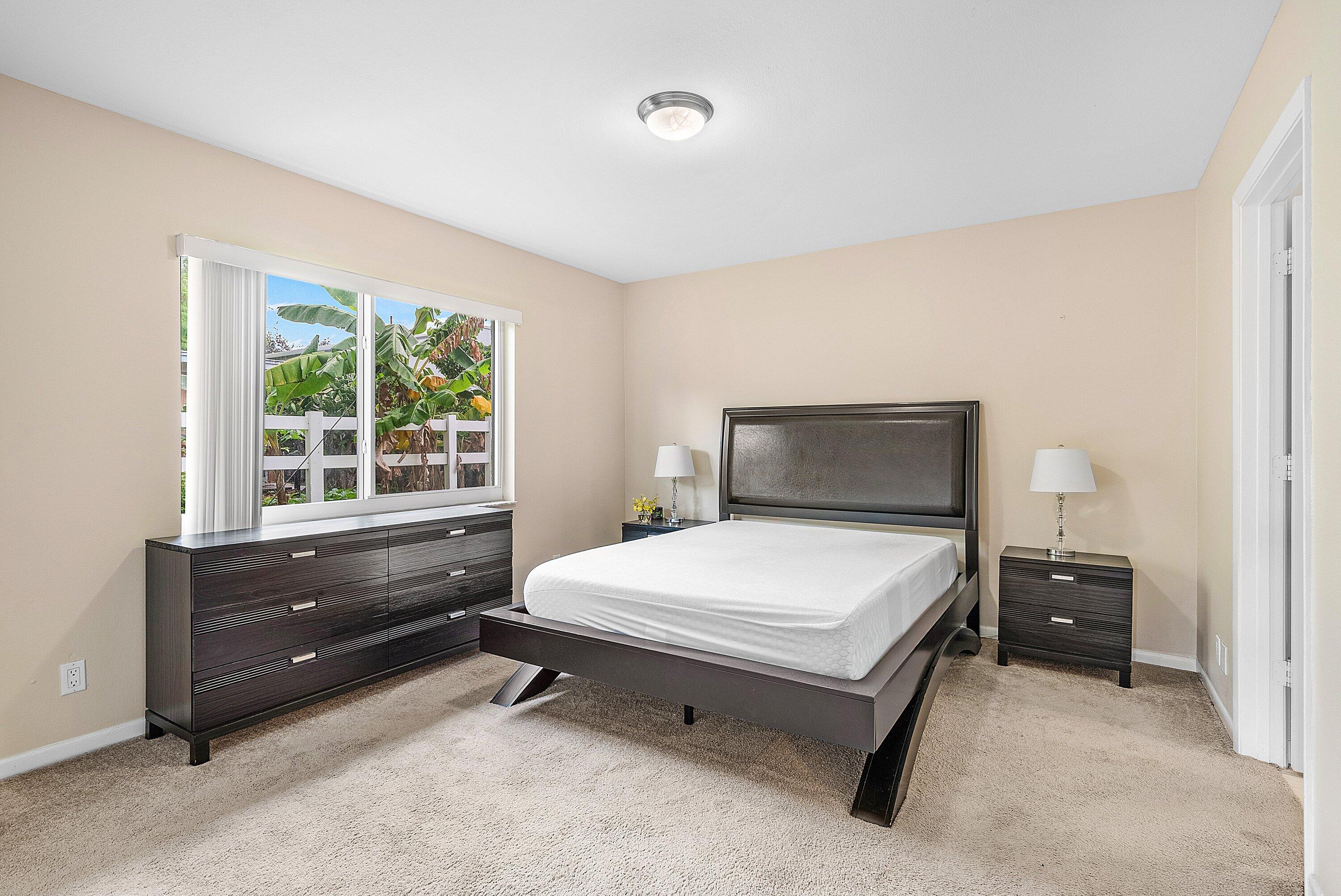 165 Northwest 8th Street Boca Raton, FL 33432 - Photo 15 of 42 a bedroom with a bed and window