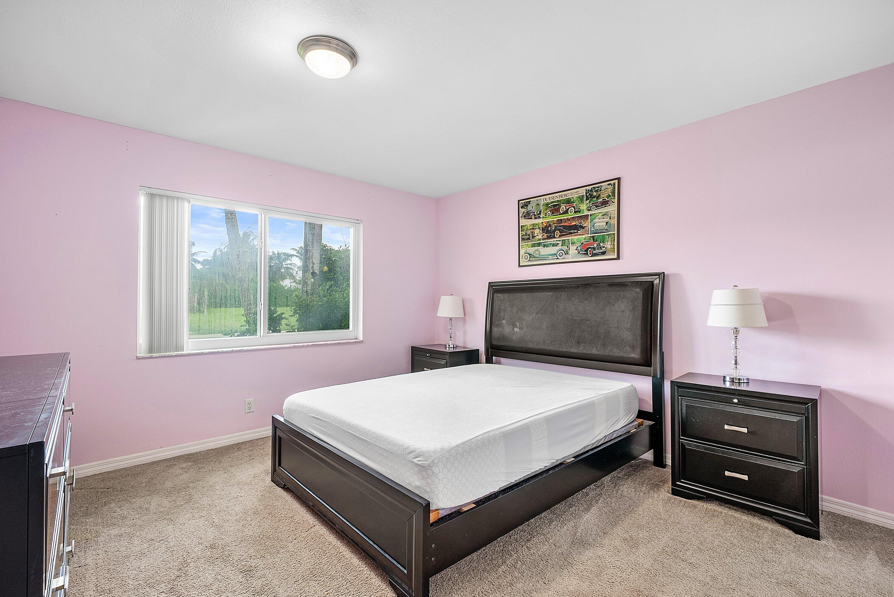 165 Northwest 8th Street Boca Raton, FL 33432 - Photo 18 of 42 a bedroom with a bed and a night stand