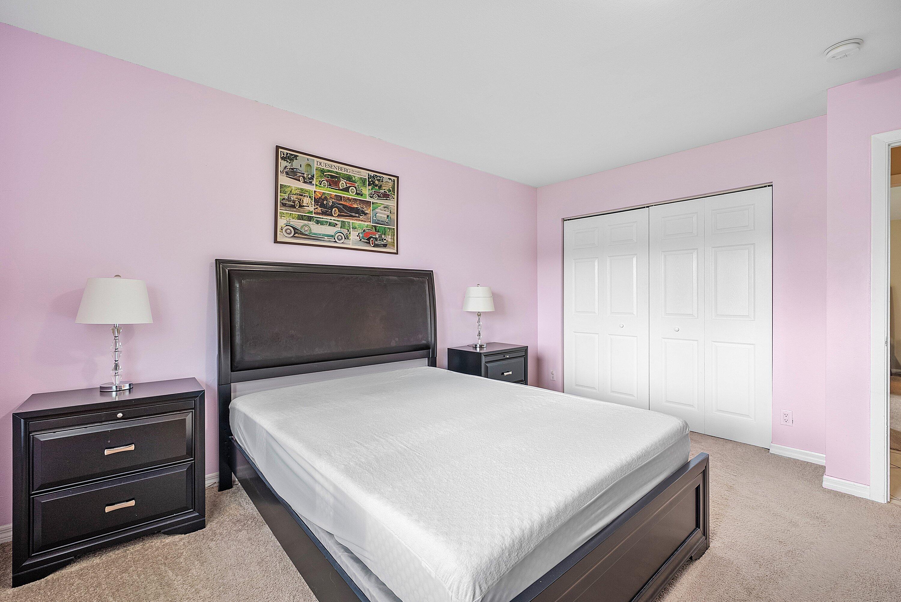 165 Northwest 8th Street Boca Raton, FL 33432 - Photo 19 of 42 a bedroom with a bed and a night stand