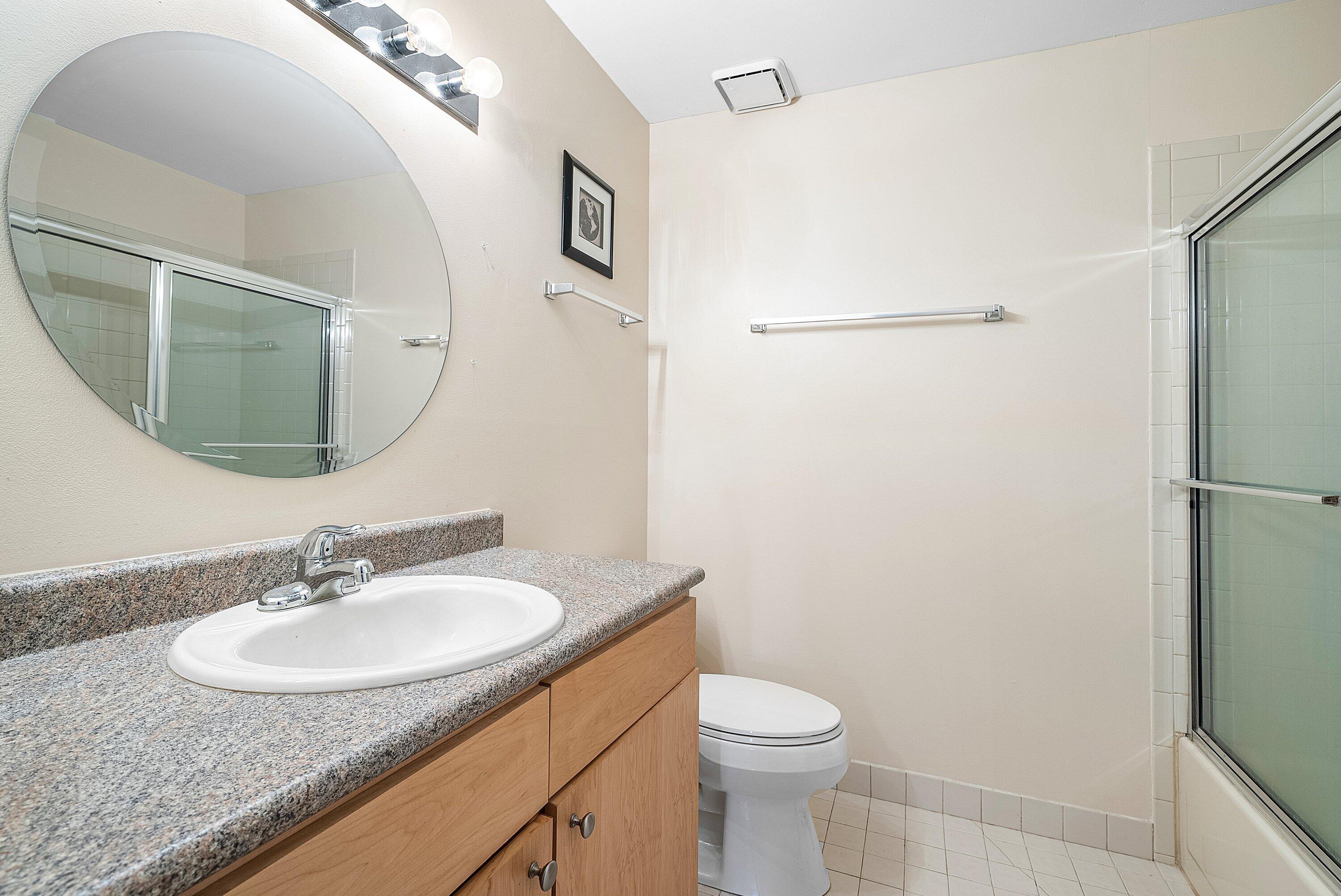 165 Northwest 8th Street Boca Raton, FL 33432 - Photo 20 of 42 a bathroom with a granite countertop sink toilet and a mirror