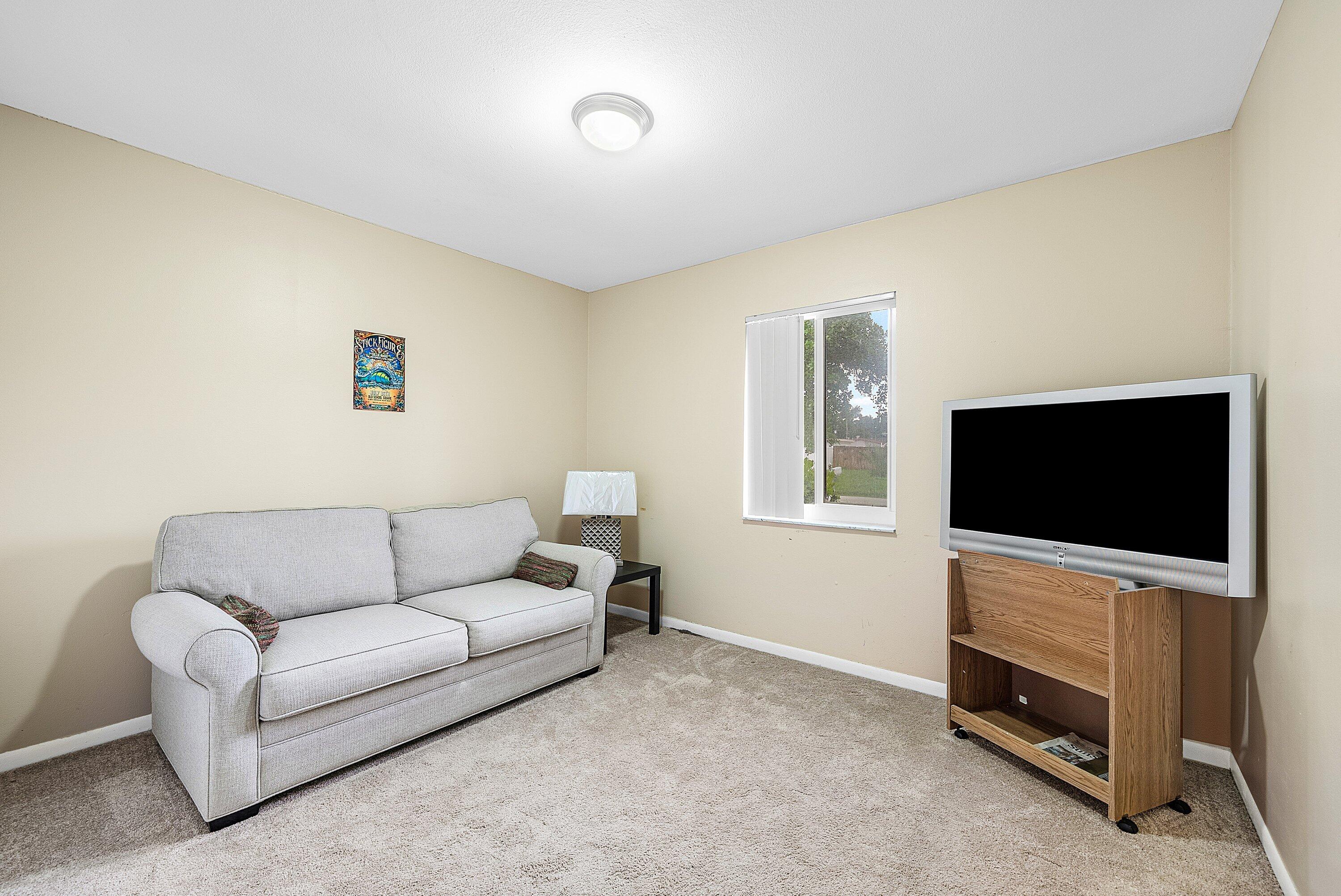 165 Northwest 8th Street Boca Raton, FL 33432 - Photo 21 of 42 a living room with furniture and a flat screen tv