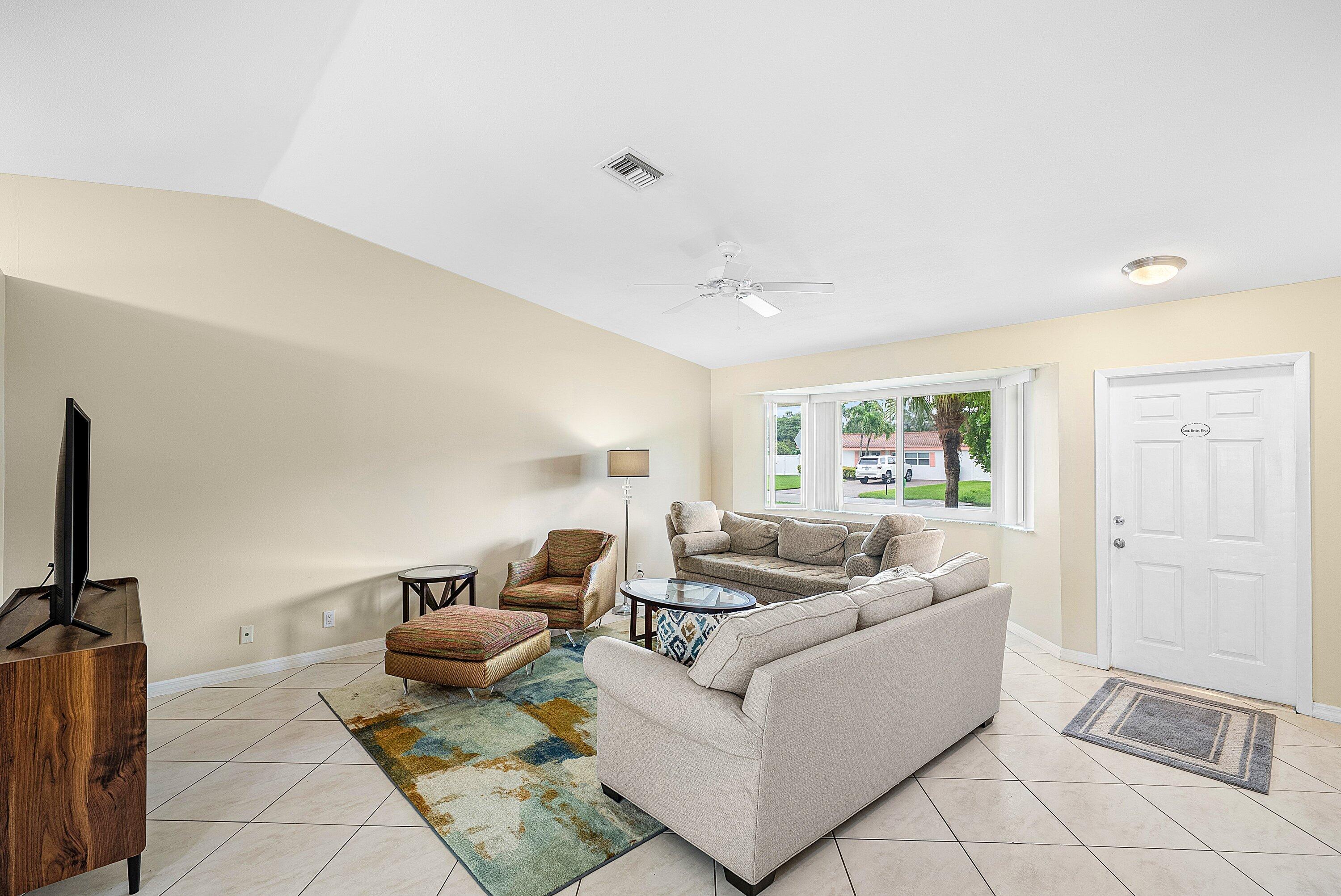 165 Northwest 8th Street Boca Raton, FL 33432 - Photo 6 of 42 a living room with furniture and a flat screen tv