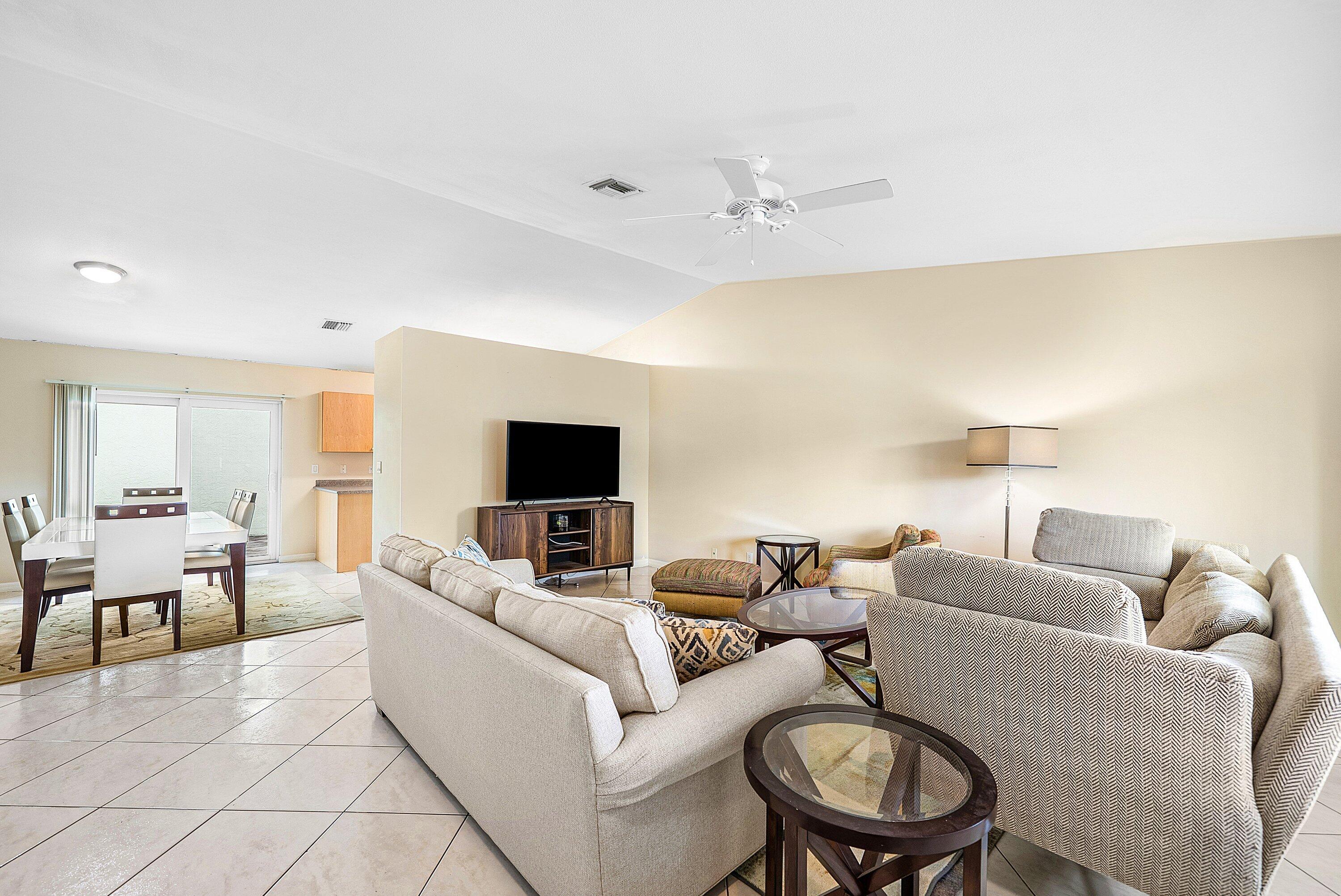 165 Northwest 8th Street Boca Raton, FL 33432 - Photo 7 of 42 a living room with furniture and a flat screen tv