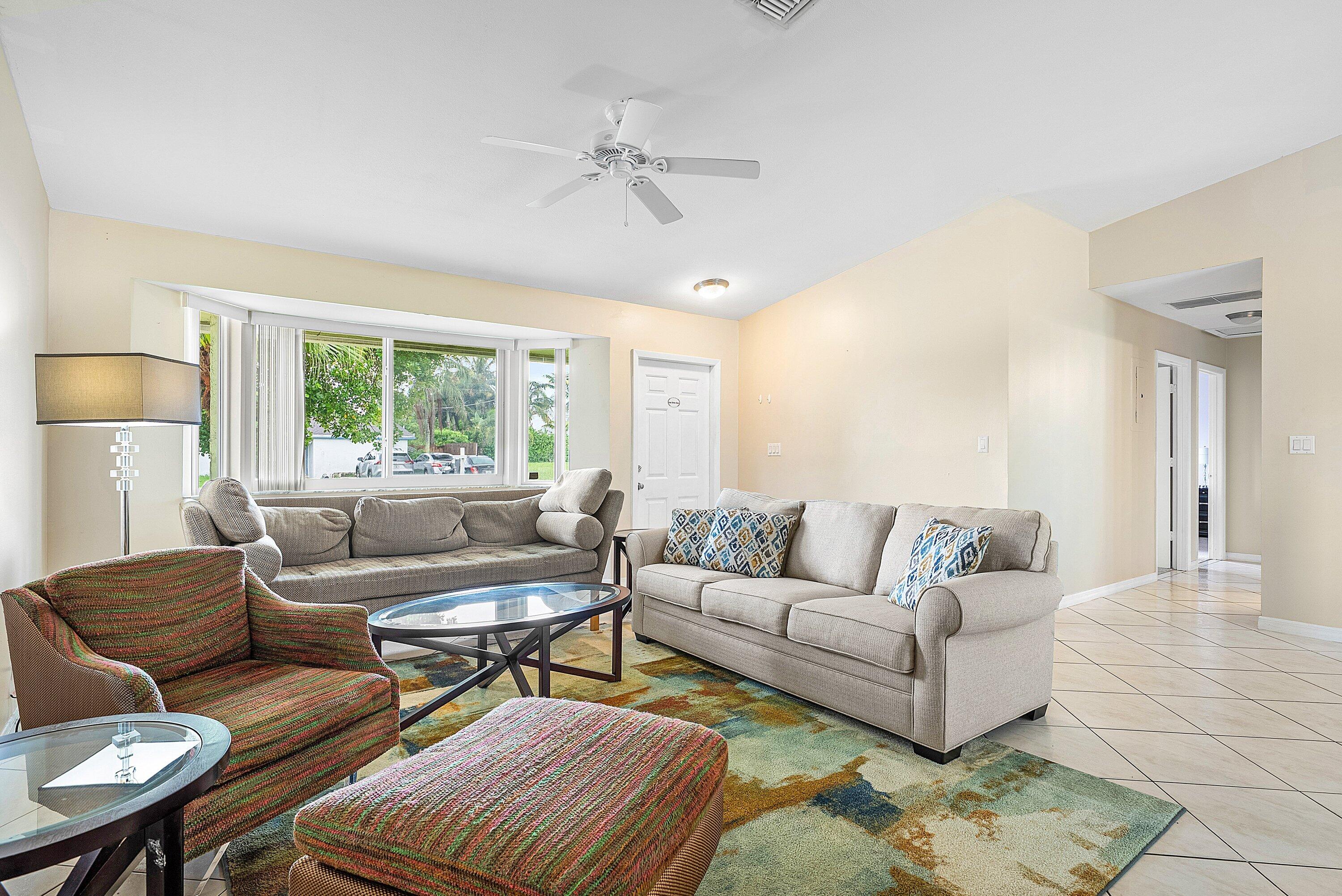 165 Northwest 8th Street Boca Raton, FL 33432 - Photo 8 of 42 a living room with furniture and a large window