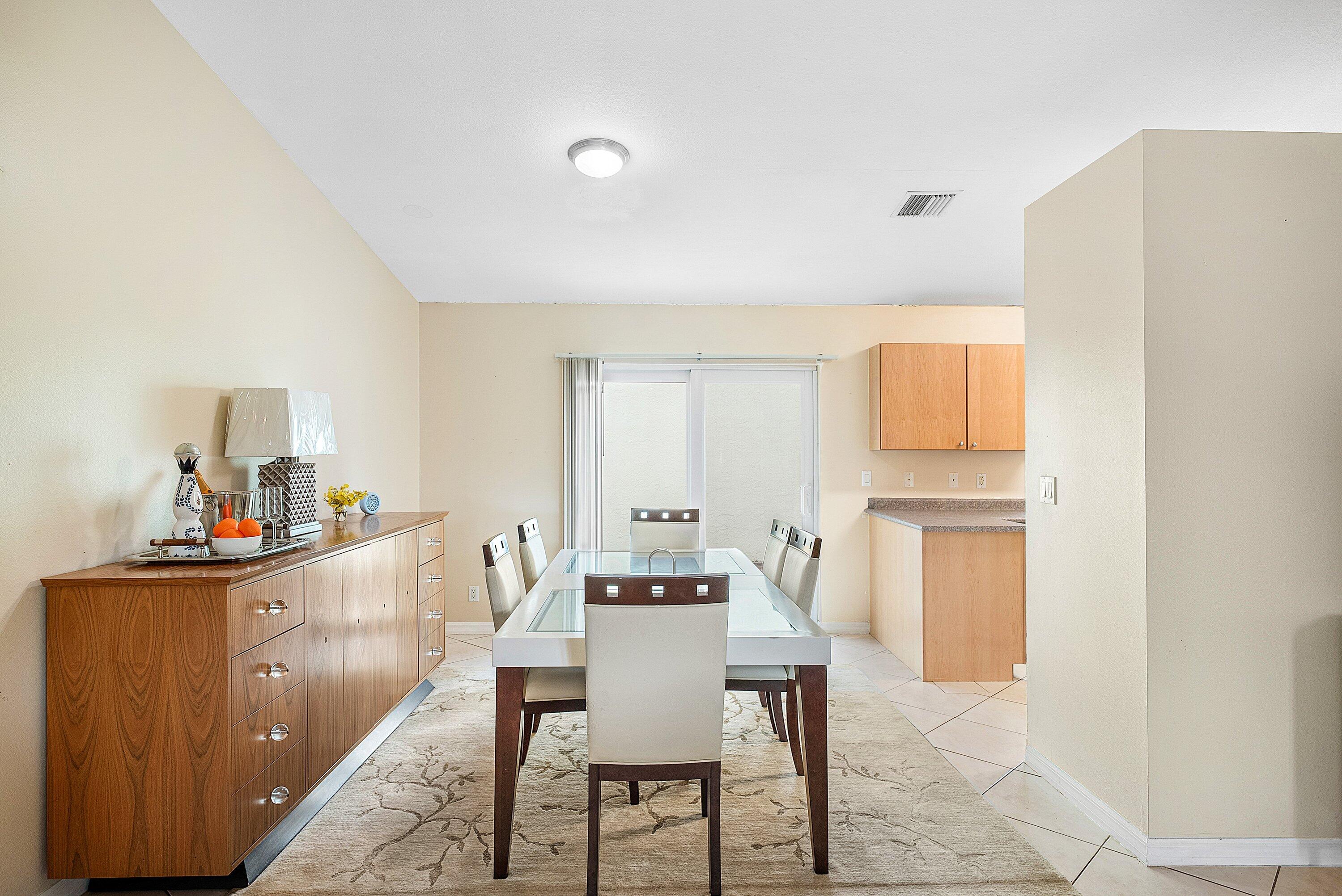 165 Northwest 8th Street Boca Raton, FL 33432 - Photo 9 of 42 a view of a dining room with furniture and a window