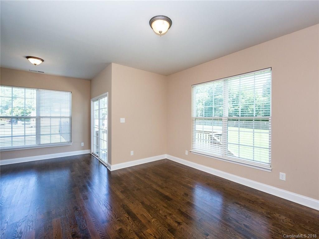 708 Baucom Road Monroe, NC 28110 - Photo 11 of 33 a view of an empty room with wooden floor and a window