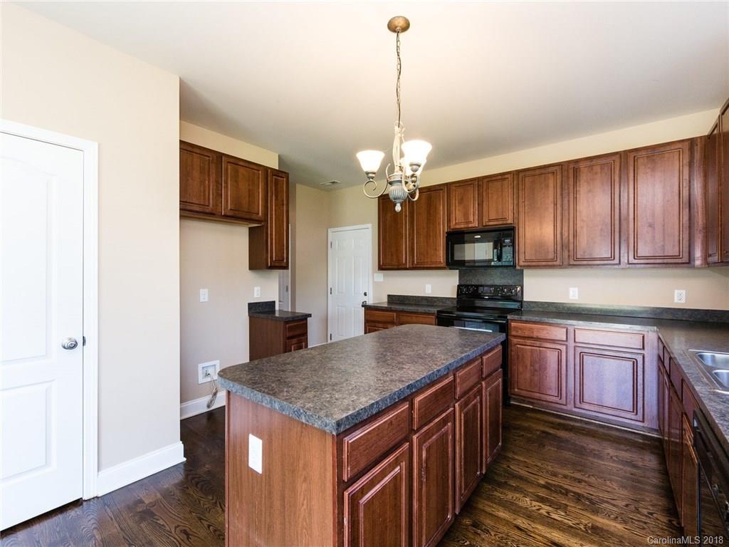 708 Baucom Road Monroe, NC 28110 - Photo 13 of 33 a kitchen with a center island and cabinets