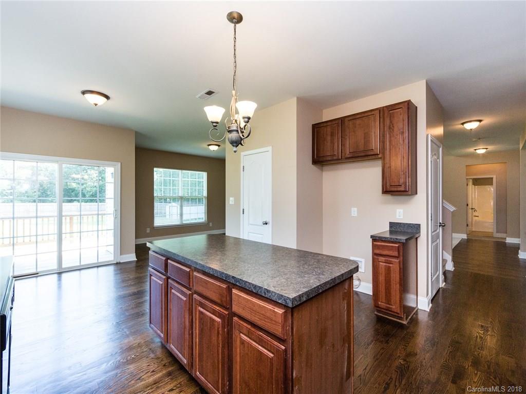 708 Baucom Road Monroe, NC 28110 - Photo 14 of 33 a kitchen with stainless steel appliances granite countertop a kitchen island a stove and a wooden floors