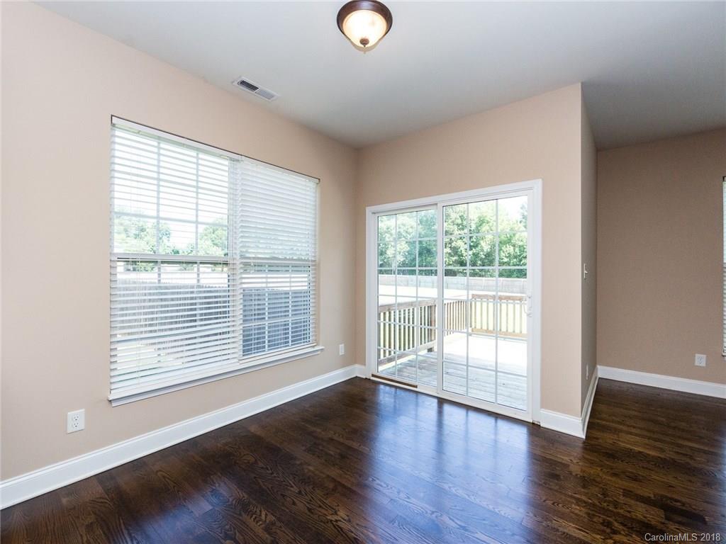 708 Baucom Road Monroe, NC 28110 - Photo 15 of 33 a view of an empty room with wooden floor and a window