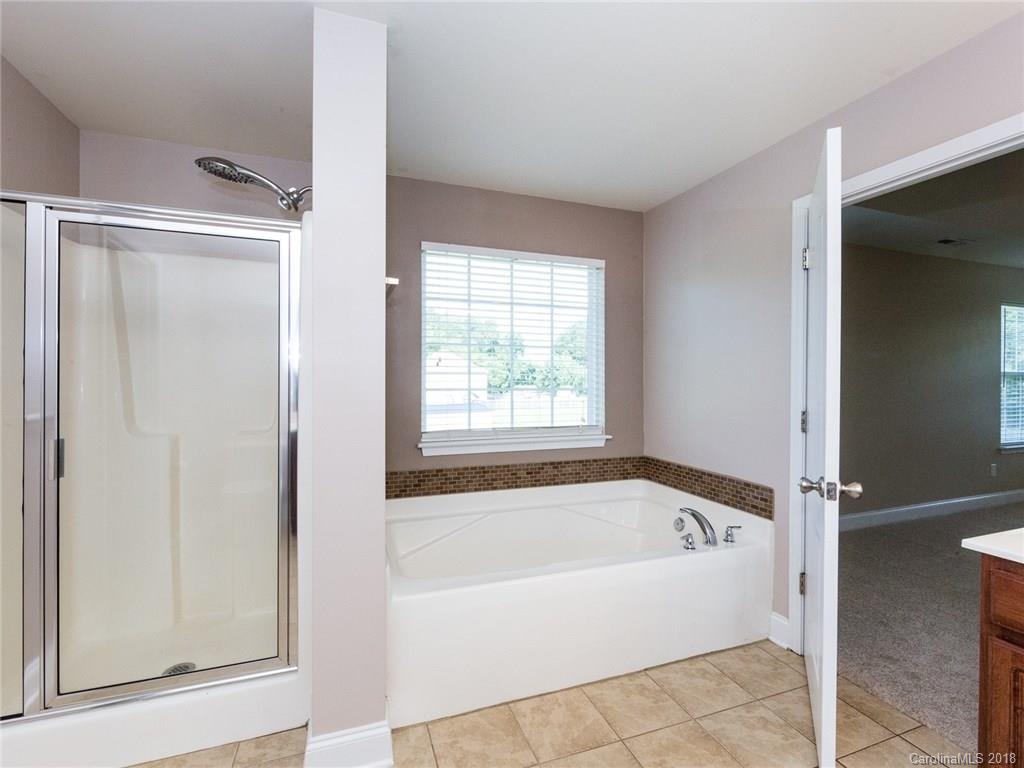 708 Baucom Road Monroe, NC 28110 - Photo 21 of 33 a white bath tub sitting next to a window