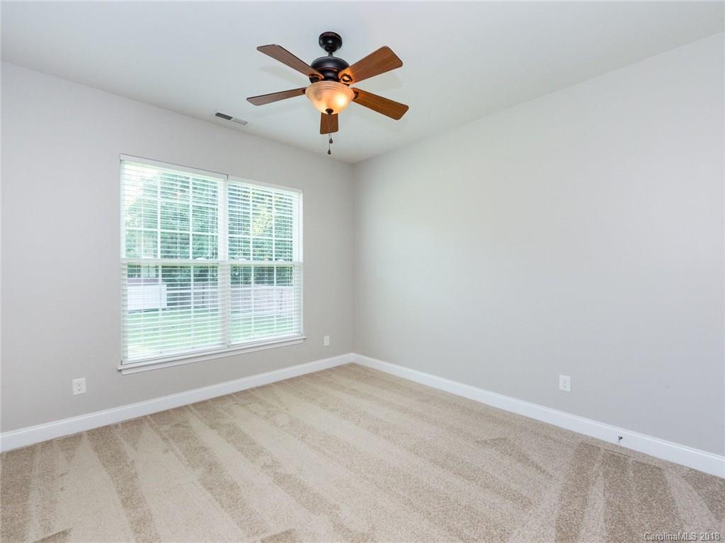 708 Baucom Road Monroe, NC 28110 - Photo 23 of 33 an empty room with ceiling fan and window