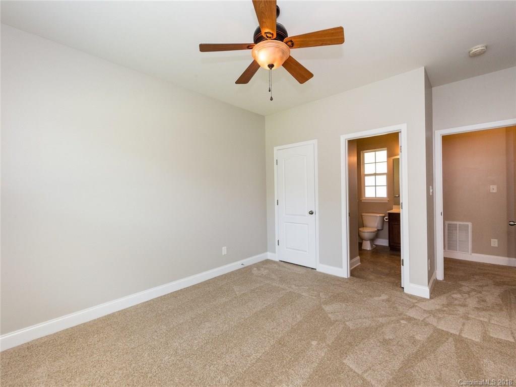 708 Baucom Road Monroe, NC 28110 - Photo 25 of 33 an empty room with closet and a chandelier fan