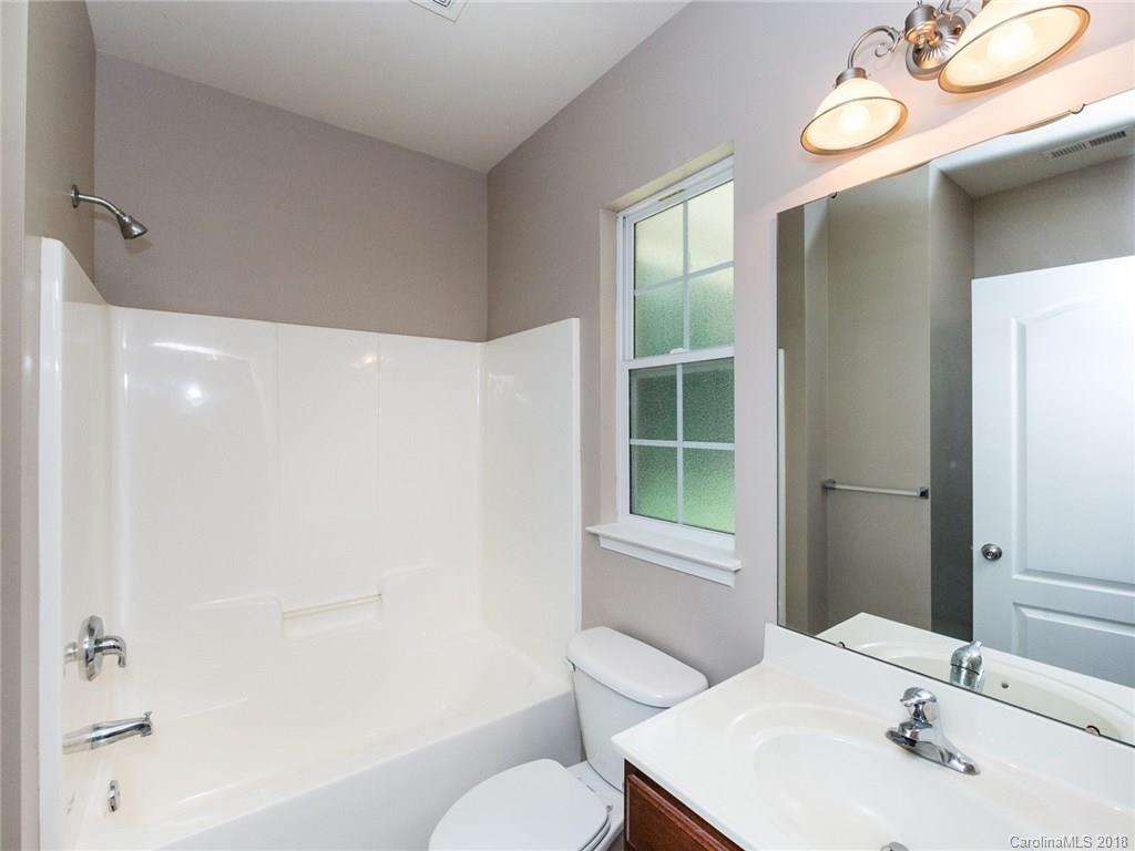 708 Baucom Road Monroe, NC 28110 - Photo 26 of 33 a bathroom with a sink vanity mirror and toilet