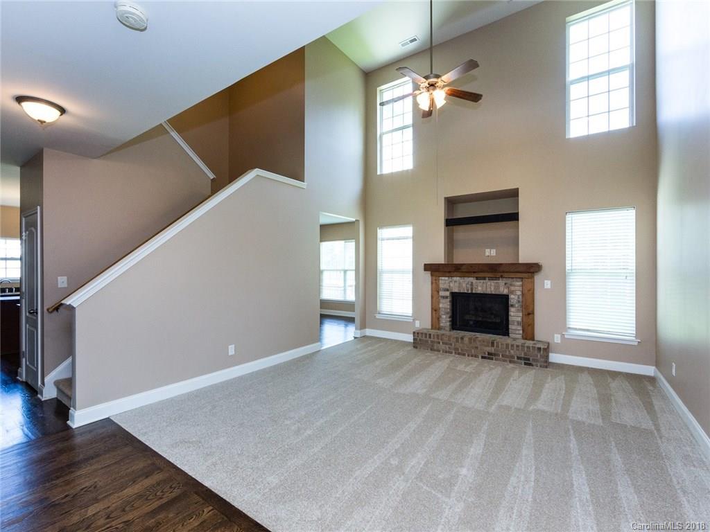 708 Baucom Road Monroe, NC 28110 - Photo 7 of 33 a view of an empty room with a fireplace and a window