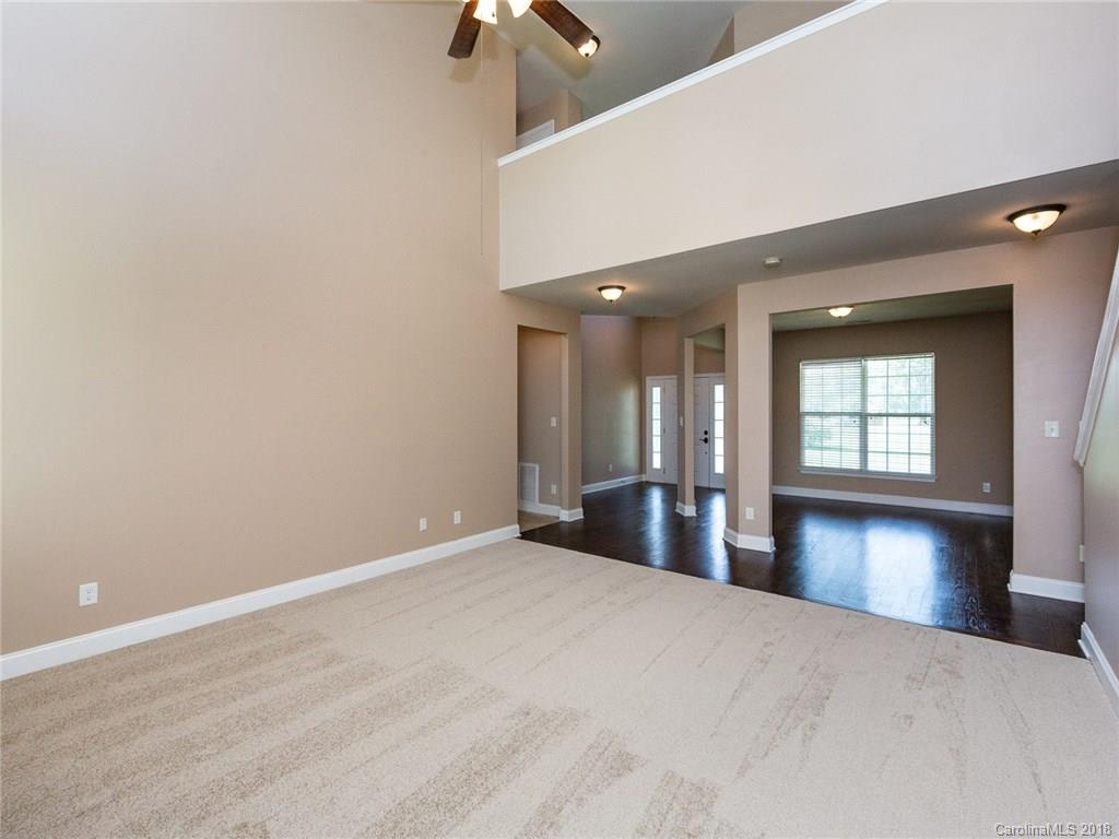 708 Baucom Road Monroe, NC 28110 - Photo 10 of 33 a view of a hallway with wooden floor and cabinet