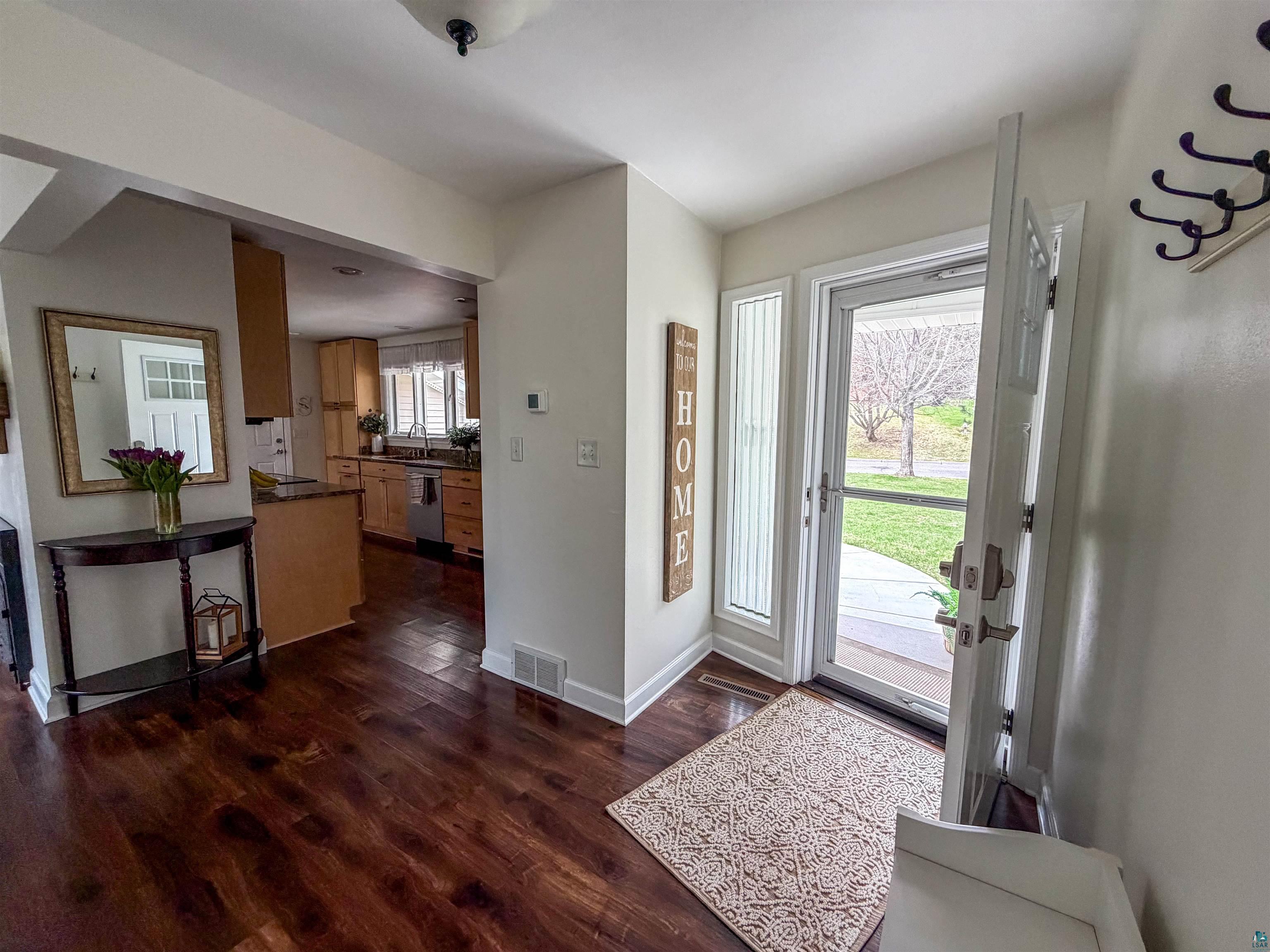 3704 Greysolon Road Duluth, MN 55804 - Photo 12 of 51 Entryway featuring dark wood-finish flooring, a white paneled front door with side light, and an overhead light fixture