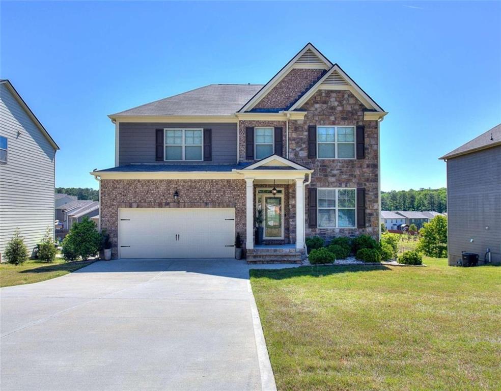 7284 Demeter Atlanta, GA 30349 - Photo 1 of 1 a front view of a house with garden