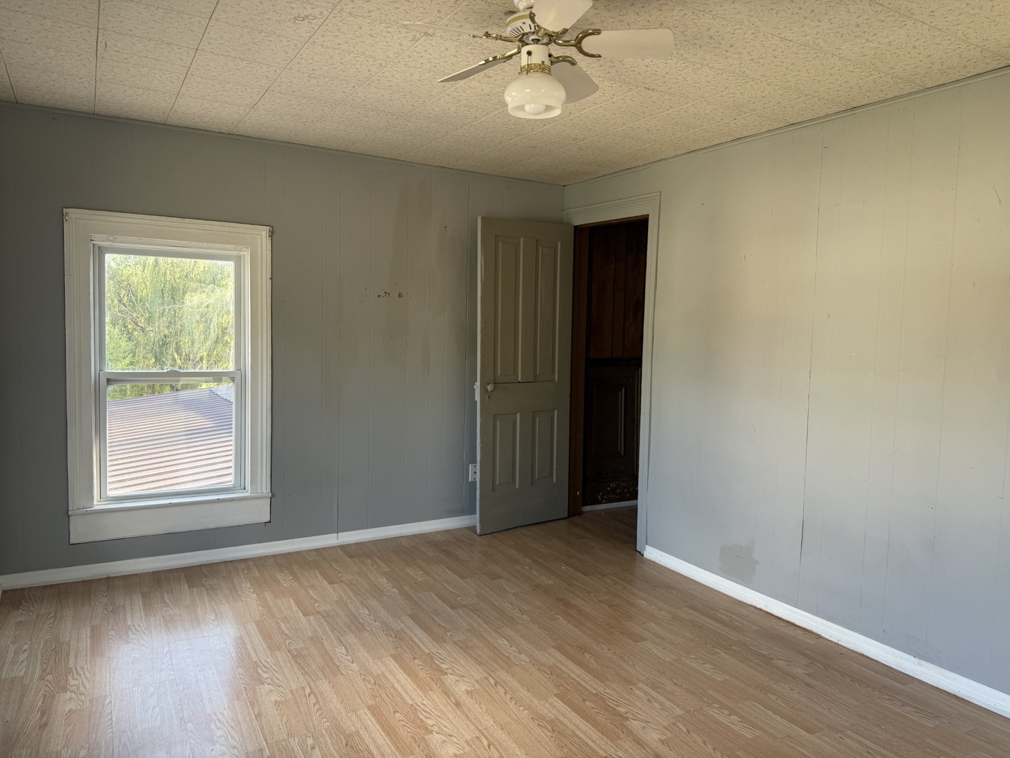 2302 1st Street Peru, IL 61354 - Photo 14 of 22 an empty room with wooden floor fan and windows