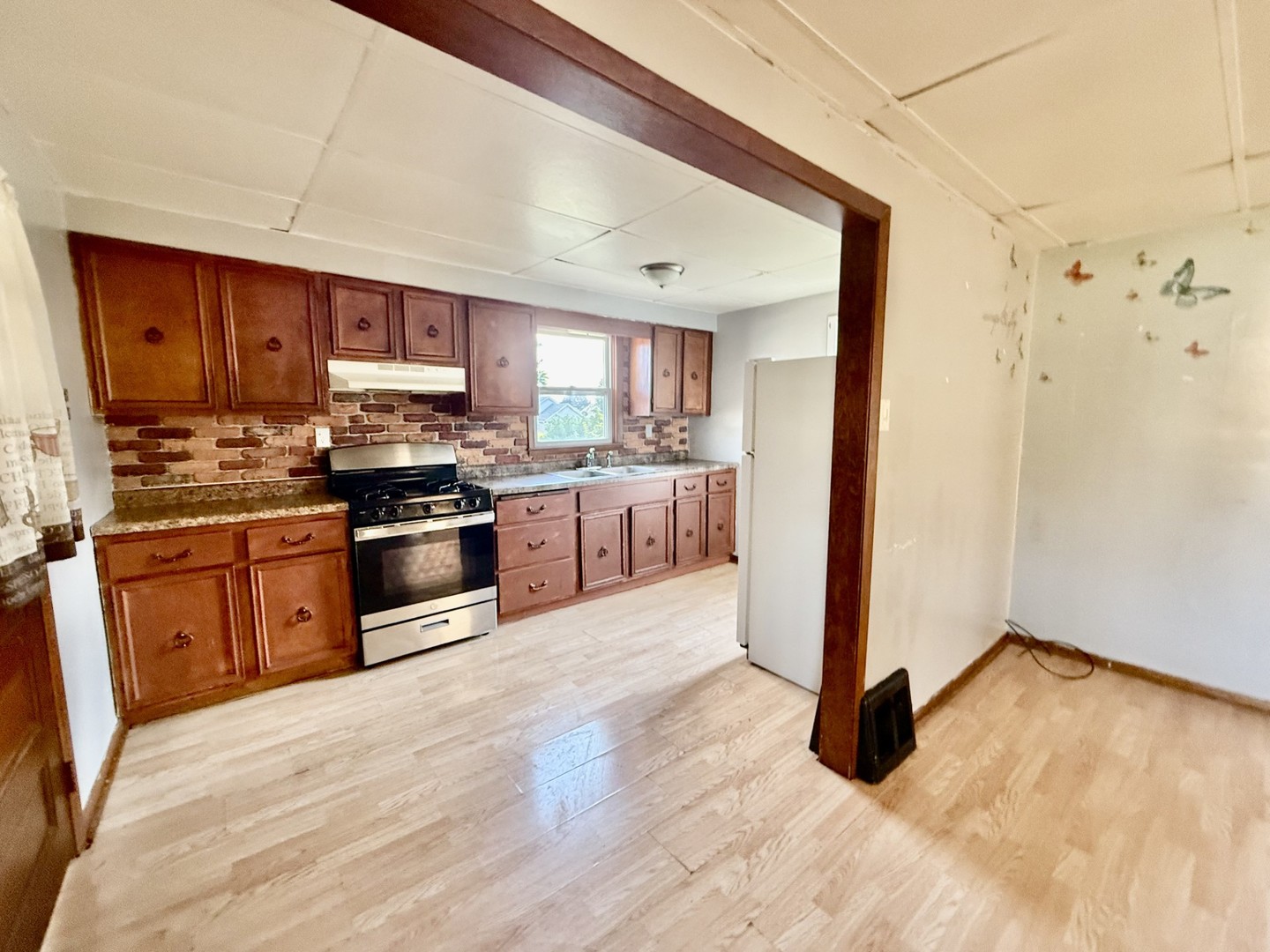 2302 1st Street Peru, IL 61354 - Photo 2 of 22 a kitchen with stainless steel appliances kitchen island granite countertop a stove a sink and a refrigerator